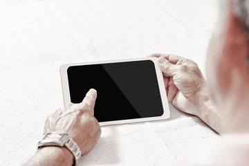Digital tablet using by senior man