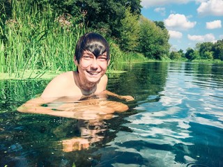 Young boy splashing in the water