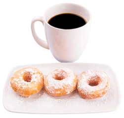 A mug of coffee and homemade doughnut with sugar toppings 