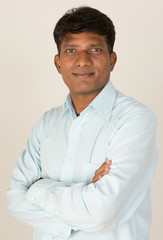 An Indian business executive with folded arms