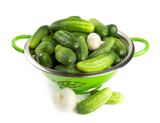 fresh cucumbers in a green colander