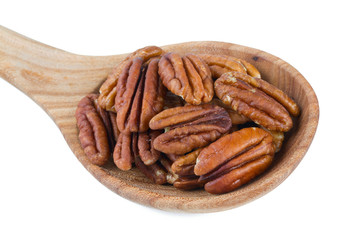 pecan nuts in a wooden spoon