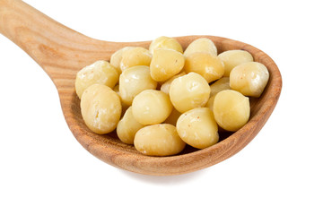 macadamia nuts in a wooden spoon