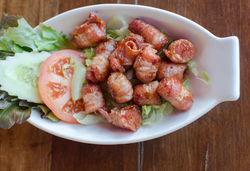 Fried pork wrapped in bacon