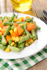 Delicious vegetables salad on plate on table close-up