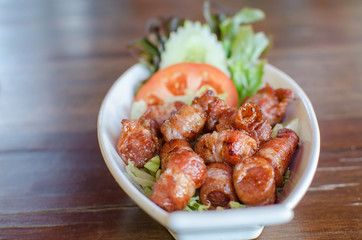 Fried pork wrapped in bacon