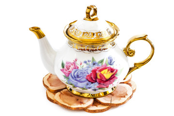 Ceramic teapot on Wooden stand .