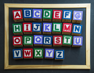 Colorful wooden alphabet on black board4