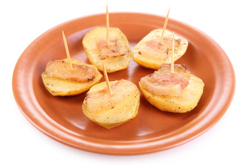 Baked potato with bacon on plate, isolated on white