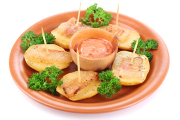Baked potato with bacon on plate, isolated on white