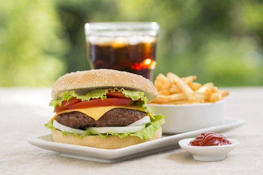 Cheeseburger with french fries and fresh drink