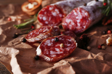 French salami and walnuts on craft paper background