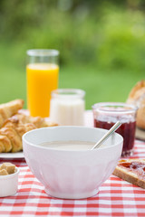 Breakfast with chocolate, orange juice, croissant, marmalade and