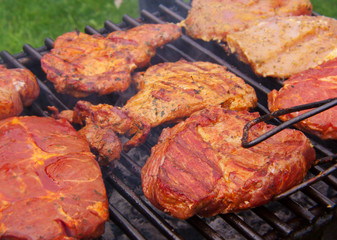 Fresh grilled steak on the grate. 