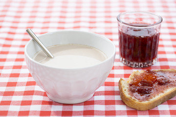 Breakfast with hot chocolate, marmalade and bread.