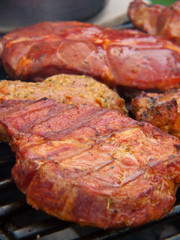 Fresh grilled steak on the grate. 