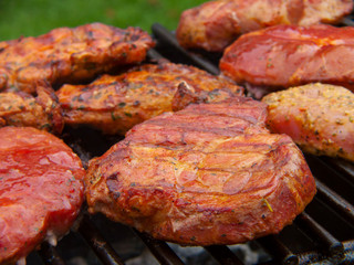 Fresh grilled steak on the grate. 