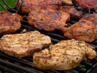 Fresh grilled steak on the grate. 
