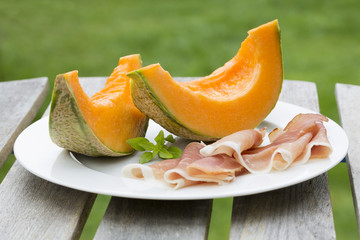 Fresh melon with serrano ham in plate