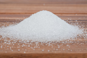 Sugar on wooden table.