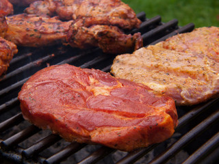 Fresh grilled steak on the grate. 
