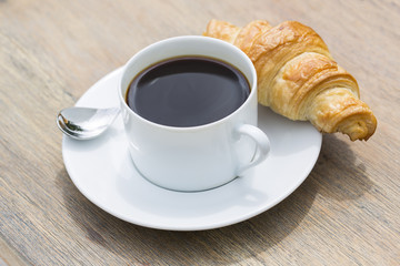 Obraz na płótnie Canvas Breakfast with cup of black Coffee and Croissant