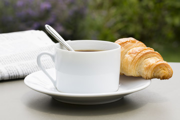 Breakfast with cup of black Coffee and Croissant