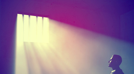 prisoner in dark room with light beams