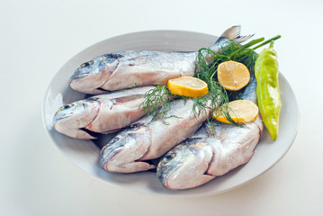 Fresh fishes with vegetables and lemon
