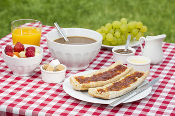 Breakfast with bread, fruits and hot chocolate
