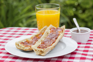 Breakfast with bread marmelade and orange juice