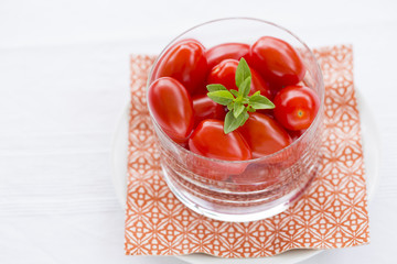 Fresh cherry tomatoes in glass bowl