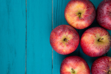 Farm fresh organic red autumn apples on wooden retro blue table