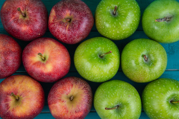 Farm fresh organic red and green autumn apples on wooden table
