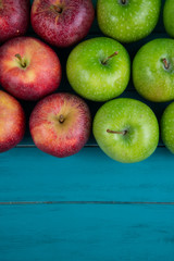Farm fresh organic red and green autumn apples on wooden table