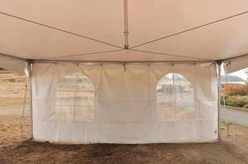 White tents in a dry field outdoors