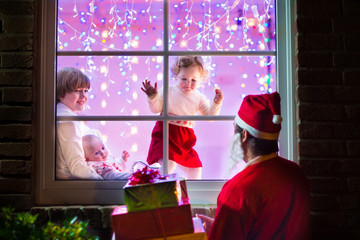 Kids looking at Santa on Christmas Eve