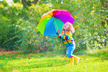 Happy little girl with umbrella