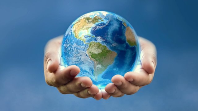 Earth in man's hands &ndash; blue background