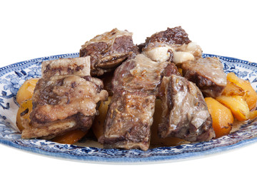 grilled meat and potatoes on a plate isolated on white backgroun