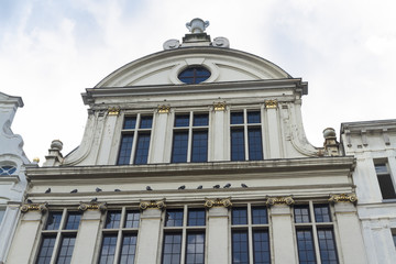 Fototapeta premium Windows and Gable stone, with pigeons resting on ledge