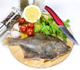 raw fish on a cutting board and knife