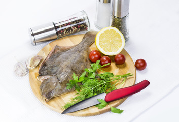 raw fish on a cutting board and knife