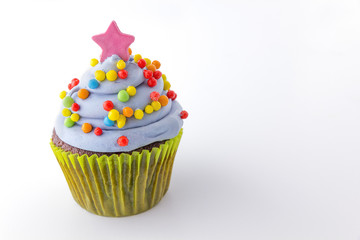 cupcake with blueberry frosting and colorful sprinkles