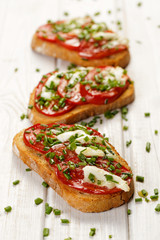 Bruschetta with fresh tomato,  cheese  and chive