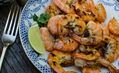 Freshly grilled shrimp on a plate with lime slice