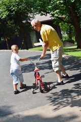 happy grandfather and child in park