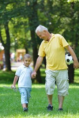 happy grandfather and child in park