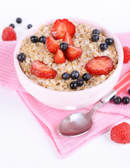 Tasty oatmeal with berries isolated on white