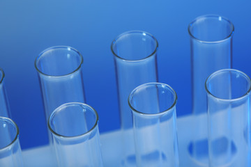 Empty test-tubes on blue background closeup